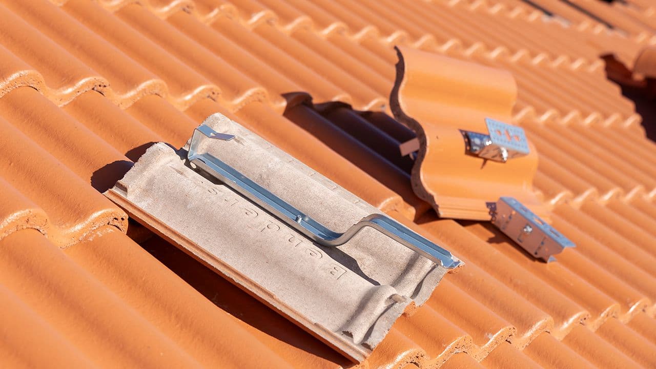 Takstein med innfestingssystem som ligger på et tak.